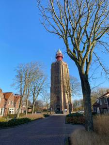 a tall building with a dome on the top of it at De Perenboom in Westkapelle +27 photos