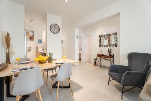 a dining room and living room with a table and chairs at Anchora in Paralimni