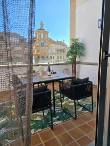 a patio with a table and chairs on a balcony at RYAP Puerta Real in Granada
