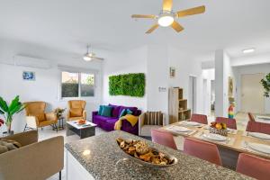 a living room with a table and a dining room at Iris Bloom Holiday Apartment in Paphos City