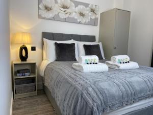a bedroom with a bed with two pillows on it at Town Centre Two-Bedroom in Swindon