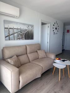 a living room with a couch and a table at Altea Beach Apartment in Altea +13 photos