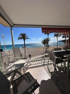 a balcony with a table and chairs and the beach at Altea Beach Apartment in Altea