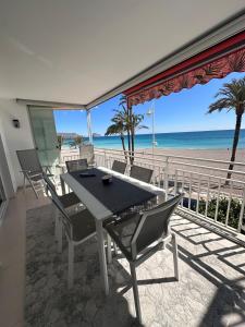 a table and chairs on a balcony with the beach at Altea Beach Apartment in Altea