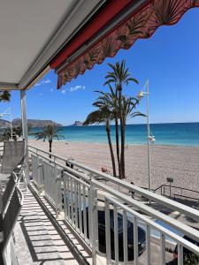a view of a beach with palm trees and the ocean at Altea Beach Apartment in Altea