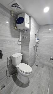 a bathroom with a toilet and a shower at The Jarrdin Apartment Cihampelas by NEMUI ROOM in Bandung +12 photos