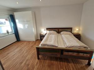 a bedroom with a bed with two pillows on it at Ferienwohnungen Dümmersee - Haus Dümmerland - Wohnung 6 in Hüde +10 photos