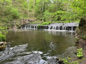 a waterfall in the middle of a river at Apartament nad Radunią in Kolbudy Dolne