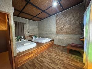 a bedroom with two beds and a wooden floor at The Nanda Resort in Ban Huai Salok +95 photos