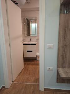 a bathroom with a sink and a mirror at Blue Waves in Vlorë +214 photos