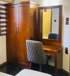 a bedroom with a desk and a chair and a mirror at Vivid Colombo in Colombo
