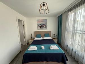 a bedroom with a bed with towels on it at Arslan Homes 4 in Marmaris