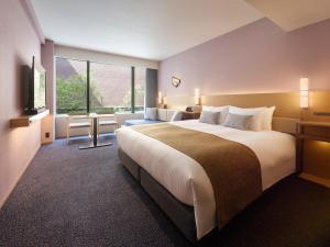 Mitsui Garden Hotel Kyoto Sanjo PREMIER客房内的一张或多张床位