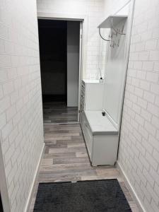a white bathroom with a sink and a mirror at Квартира 43 in Karagandy