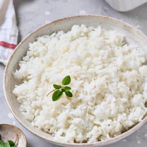 a bowl of white rice with a green garnishment at Kaween Homestay in Weligama