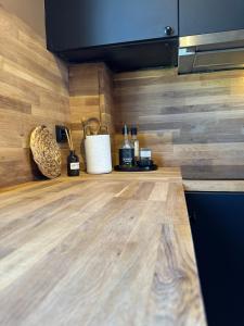 a kitchen with a counter top with bottles of wine at A Place To Stay Stavanger, apartment 6 in Stavanger +9 photos