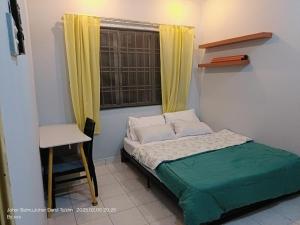 a small bedroom with a bed and a window at Furry Companion Stay at Larkin in Johor Bahru