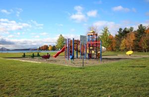 a playground with a slide in a park at Le Paréo de Magog-Mont Orford in Magog-Orford