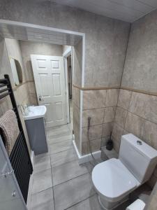 a bathroom with a toilet and a sink at Ulverston Town Centre Ground Floor Apartment in Ulverston +9 photos