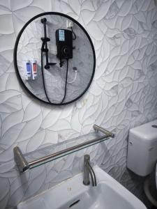 a bathroom with a mirror and a sink at Jaya Homestay KT in Kota Tinggi +11 photos