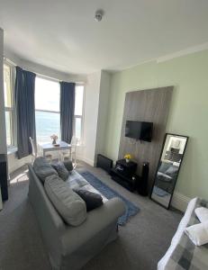 a living room with a couch and a table at Farina No5, Sea view studio sleeping 2 guests in Bridlington