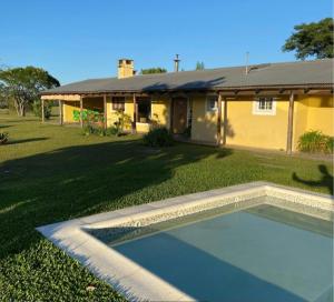 a house with a swimming pool in front of a yard at Concordia, Argentina in Concordia