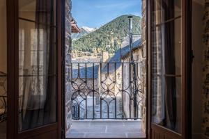an open door to a balcony with a view at Casa Natal del Gigante de Sallent in Sallent de Gállego