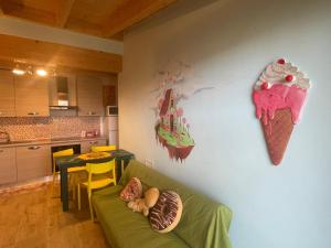 a living room with a couch and an ice cream clock at La casetta di marzapane casa-natura in Senigallia