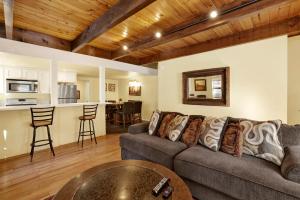 a living room with a couch and a table at Buttercup Snow Summit Condo by Big Bear Vacations in Big Bear Lake