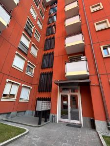 an orange building with a door in front of it at La finestra sul trenino in Tirano