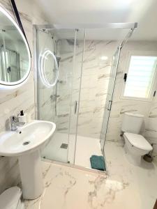 a bathroom with a shower and a sink and a toilet at Playa del Pinar home in Grao de Castellón +14 photos