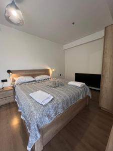 a bedroom with a large bed with two towels on it at Nirvana Stayz Gudauri in Gudauri