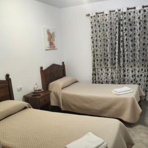 Ένα ή περισσότερα κρεβάτια σε δωμάτιο στο APARTAMENTOS MARIA
