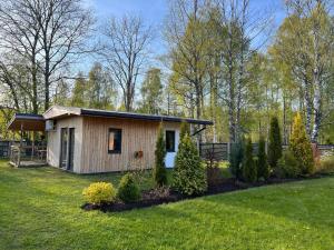 a small house in the middle of a yard at Vacation house in Saulkrasti