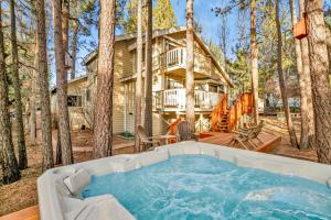 a log home with a hot tub in the woods at Modern Luxury Retreat - Sacred Stone Big Bear in Big Bear Lake