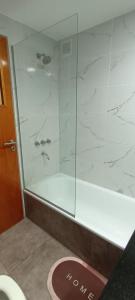 a shower with a glass door in a bathroom at Departamento Barrio Martin in Rosario