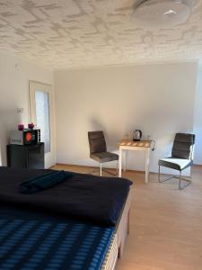 Un dormitorio con una cama y dos sillas y una mesa. en Privates Zimmer Gemeinschaftsbad keine Küchen, en Núremberg