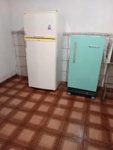 a refrigerator in a kitchen with a tile floor at Tecnoshow 2025 - casa in Rio Verde