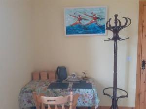 a bedroom with a table with two chairs at Nature's Edge in Moneyduff