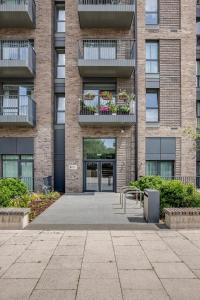 an apartment building with a patio and a courtyard at Modern, Spacious 2bed, 2bath apartment in Barking in Barking +18 photos