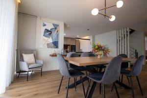 a dining room with a wooden table and chairs at Villa with Pool Casa Sol Poente by casaporto207 in Vila Verde
