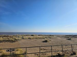 a view of the desert with the ocean in the background at Ingoldmells golden sands plot 152 in Ingoldmells +3 photos