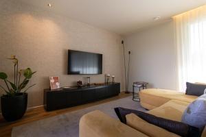 a living room with a couch and a flat screen tv at Villa with Pool Casa Sol Poente by casaporto207 in Vila Verde