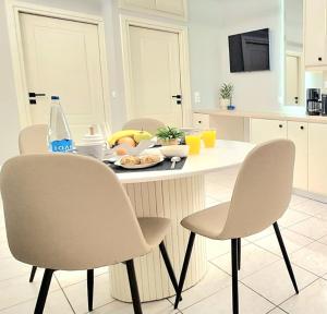 a kitchen with a table and chairs with a plate of food at Philokali in Sitia +8 photos