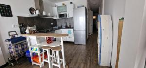 a kitchen with a table and a refrigerator at Porto A Guarda in A Guarda