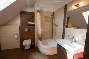 a bathroom with a toilet and a tub and a sink at Willa Hydrograf in Ustka +85 photos