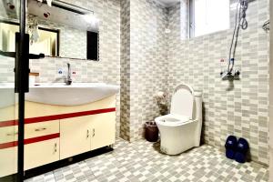 a bathroom with a sink and a toilet and a mirror at Nicer Family in Leshan +14 photos
