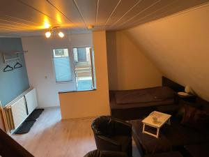 a living room with a couch and a bed at Relax in Wilster