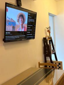 a flat screen tv hanging on a wall at Azure staycation by marco in Manila