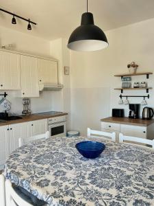 a kitchen with a table with a blue bowl on it at Holiday Home Villa Emma in Debeljak